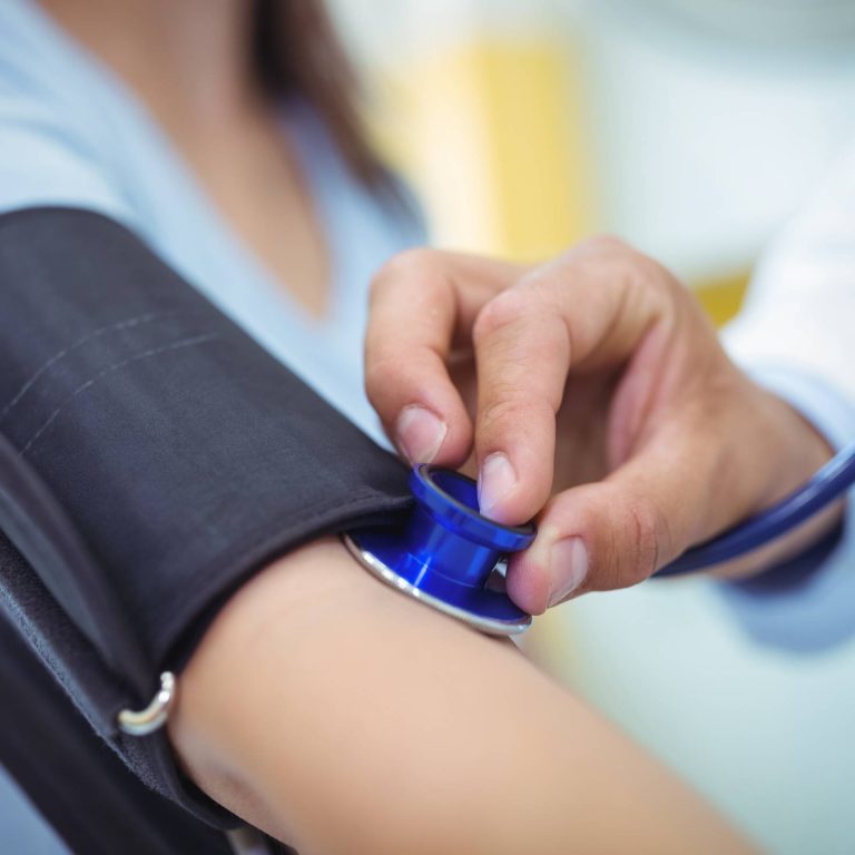 doctor-checking-female-patient-blood-pressure(1)