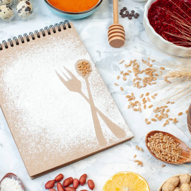 front-view-simple-notepad-with-flour-eggs-jelly-different-nuts-white-background-fruit-nut-sugar-color-pie-photo-sweet-cake-dough(1)
