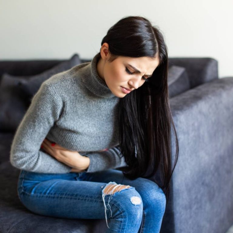 sick-woman-having-stomachache-living-room(1)